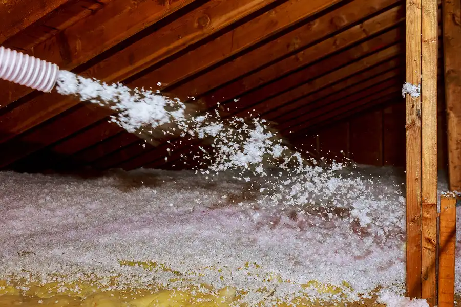 A Barnes Wildlife Control team sprays pest control attic insulation into an attic of a Miami Valley home.
